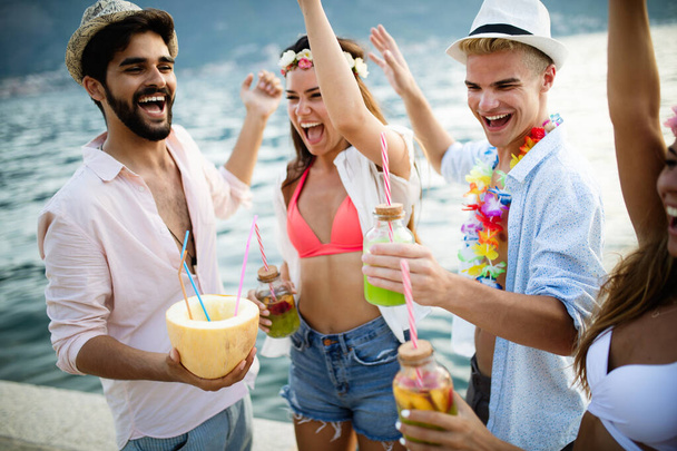 Group of friends having fun and party on the beach. Summer, vacation, music, people concept - Foto, Imagen