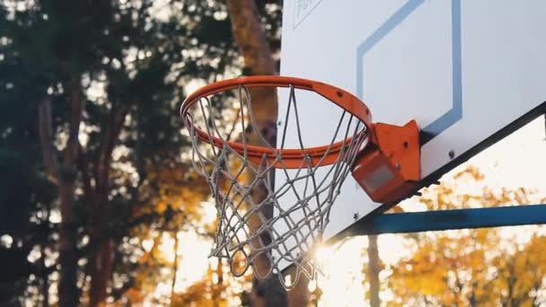 Sonnenstrahlen durchbrechen einen Basketballkorb. - Filmmaterial, Video