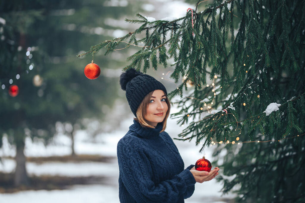 Woman near christmas tree outdoor - Photo, Image