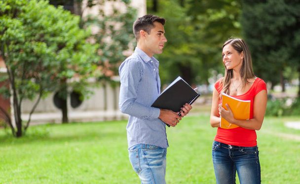 Couple of students talking together - 写真・画像