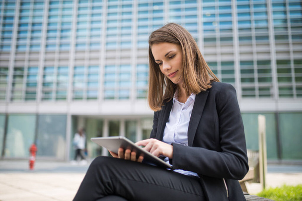 Portrait of a young woman using a tablet in front of her office - Foto, Imagem