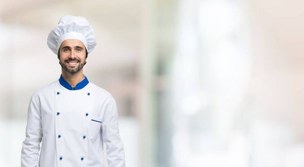 Smiling chef in front of a large wide bright background - Fotografie, Obrázek
