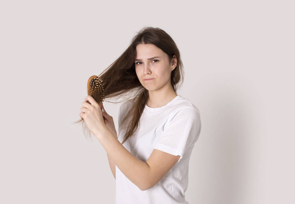 young girl brushing her broblems unhealth dry hair isolated - Fotoğraf, Görsel