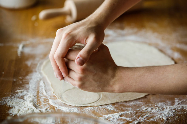 Closeup of woman cooking meal with dough - Photo, image