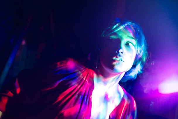 Psychedelic portrait of a girl with multi-colored lights. - Photo, Image