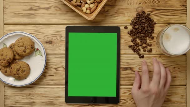 Crop nervous person tapping fingers near tablet and breakfast food - Footage, Video