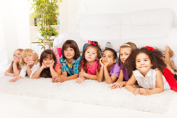 Many kids in a row on the floor at home - Foto, Bild