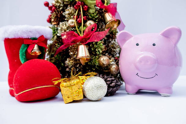 piggy bank and Beautifully decorated Christmas tree with a holiday party beginning in the new year and crossing to year 2020 - Фото, зображення