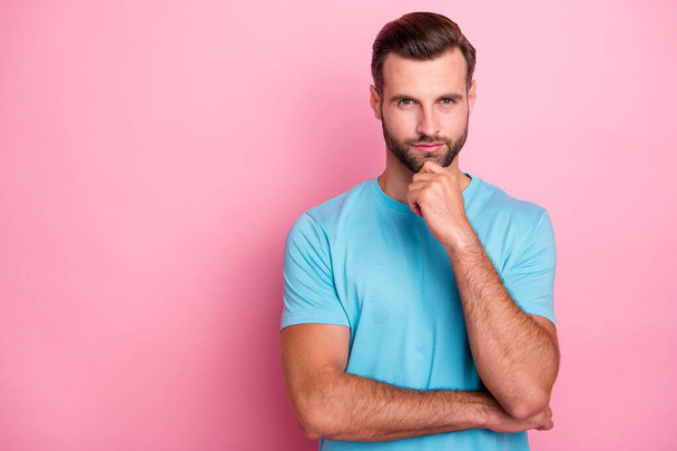 Photo of serious confident man with bristle touching his chin bearded looking at you pensively isolated pink pastel color background - Valokuva, kuva