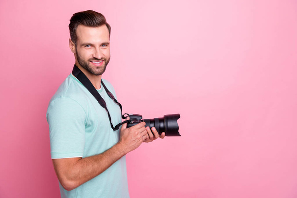 Profile side photo of positive man have rest relax spring vacation want shooting hold big dslr camera wear modern clothing isolated over pastel color background - Fotó, kép
