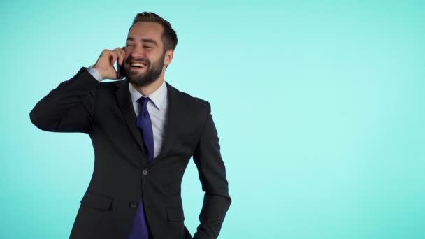 Businessman have conversation using mobile phone isolated on blue background. Copy space. Business guy in formal suit gladly talks with colleague. Office employee, wage worker, weekdays concept - Video