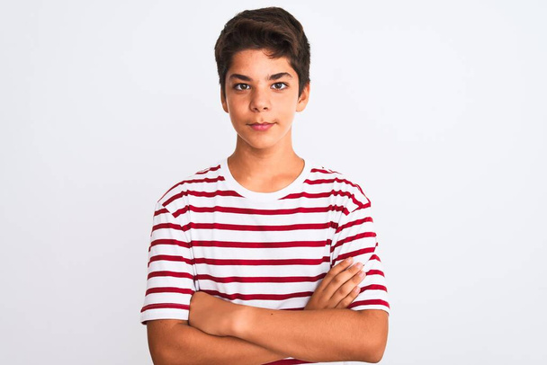 Handsome teenager boy standing over white isolated background skeptic and nervous, disapproving expression on face with crossed arms. Negative person. - Photo, Image