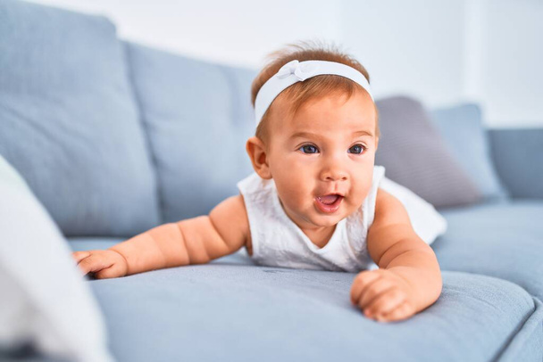 Adorable baby lying down on the sofa at home. Newborn relaxing and resting comfortable - Φωτογραφία, εικόνα