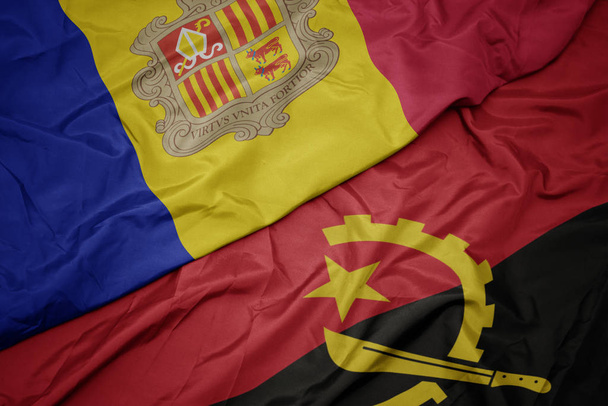 machanie kolorowe flagi angoli i flagi narodowej andorry. - Zdjęcie, obraz