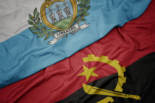 хвилястий барвистий прапор Анголи і національний прапор Сан-Марино
. - Фото, зображення