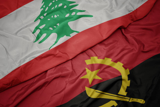 waving colorful flag of angola and national flag of lebanon. - Photo, Image