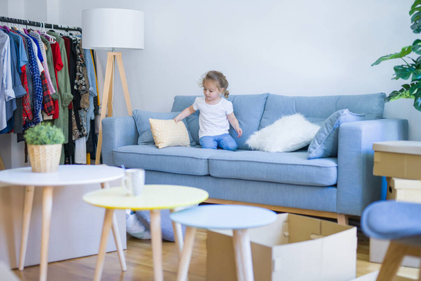 Beautiful toddler child girl jumping on the sofa - Photo, image