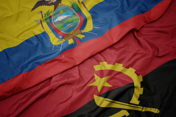 アンゴラのカラフルな旗やエクアドルの国旗を振って. - 写真・画像