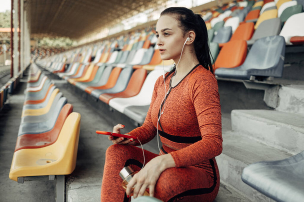 Portrait of One Sports Fitness Girl Dressed Fashion Sportswear Outfit Doing Exercise and Training at the City Stadium, Healthy Lifestyle Concept - Фото, изображение