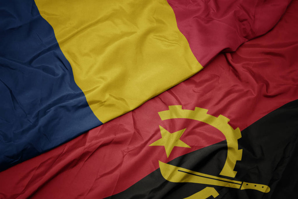 machanie kolorowe flagi angoli i flagi narodowej chad. - Zdjęcie, obraz