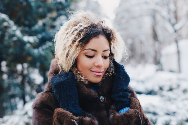 Winter young african woman portrait in park. - Photo, image