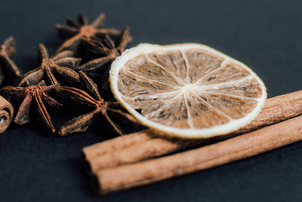 Traditional Christmas spices - Star anise with cinnamon and dry lime on a dark background. - Photo, Image