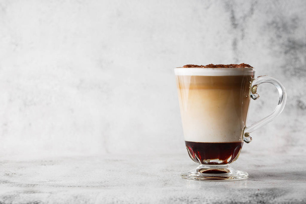 Coffee with Irish whiskey and whipped cream in glass isolated on bright marble background. Overhead view, copy space. Advertising for cafe menu. Coffee shop menu. Horizontal photo. - Foto, Bild