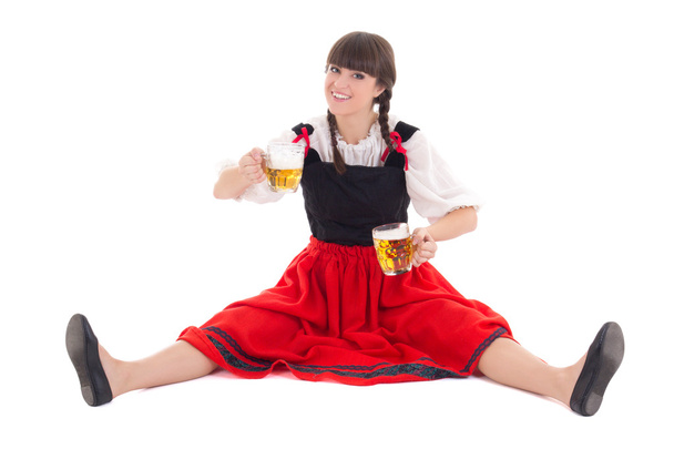 Bavarian girl sitting with cups of beer - Photo, Image