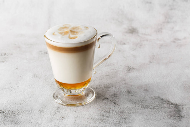 Coffee with Irish whiskey and whipped cream in glass isolated on bright marble background. Overhead view, copy space. Advertising for cafe menu. Coffee shop menu. Horizontal photo. - 写真・画像