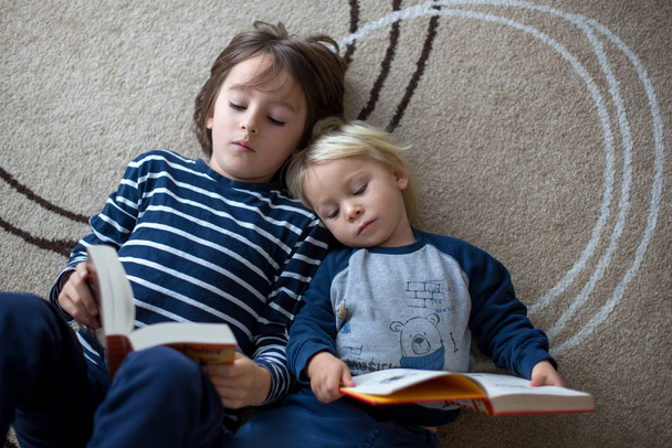 Cute child, boy, reading a book at home - Foto, Bild