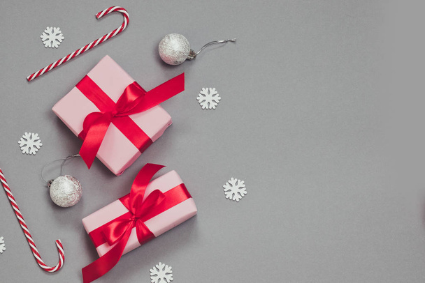 Zimowy świąteczny baner z papierowymi prezentami, złotymi elementami, cukierkami, konfetti i kulkami. - Zdjęcie, obraz