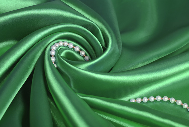 Pearl beads on green silk - Photo, Image
