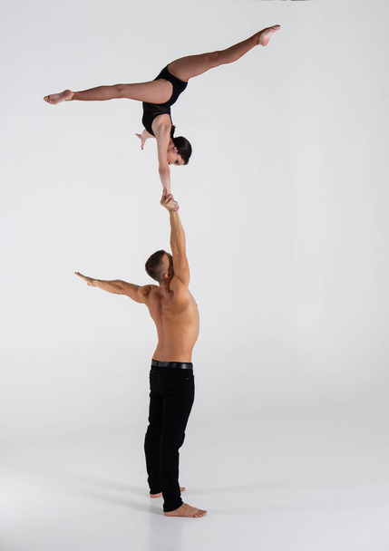 Duo Of Acrobats Showing hand to hand Trick, Isolated On White - Valokuva, kuva