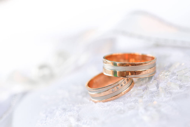 Two bronze wedding rings on white textile - Photo, Image