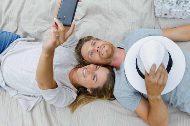 happy beautiful couple taking a selfie with smartphone - Фото, зображення