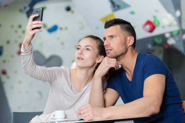 two young friends taking a selfie indoors - Photo, Image