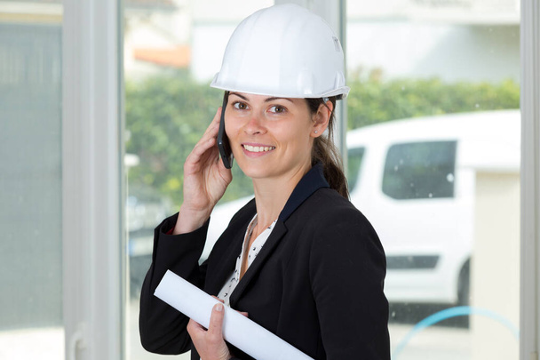 portrait of a woman engineer on the phone - Photo, image
