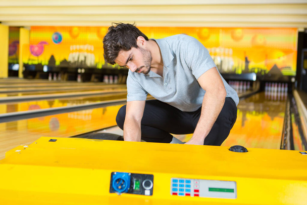 handsome employee maintaining bowling alleys - Photo, Image