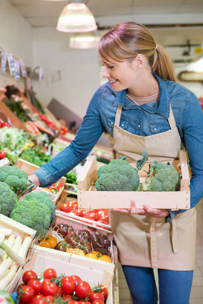 woman buys a broccoli in a store - Fotó, kép