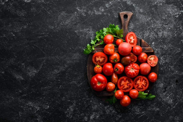 Fresh red tomatoes on white wooden background. Greens. Top view. Free space for your text. - Foto, imagen