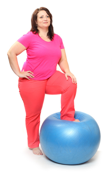 Happy overweight woman with blue ball exercising - Foto, immagini