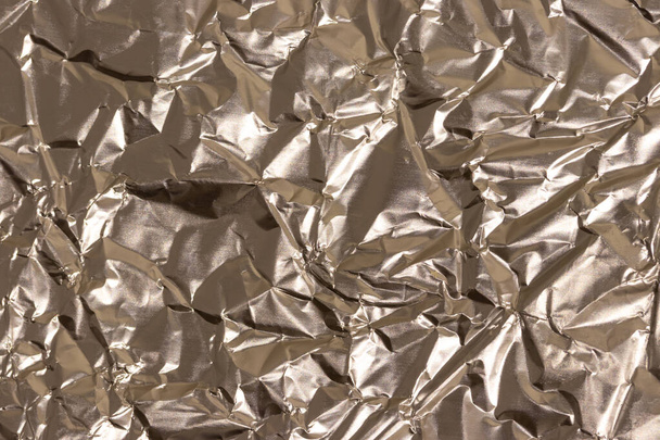 Texture of crumpled golden foil. Abstract background for design. - 写真・画像