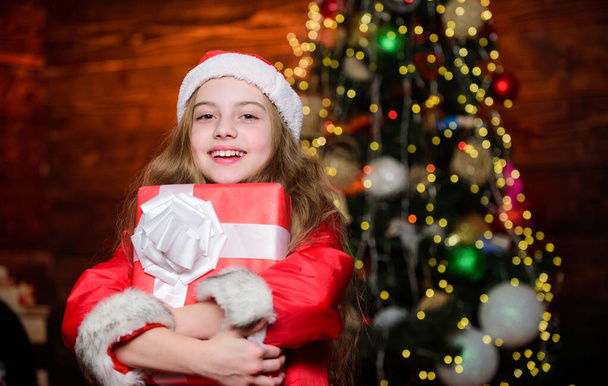 Winter holidays. Shopping and sale. Christmas is time for giving. Festive atmosphere christmas day. Girl santa claus costume hold christmas gift box. Prepare surprise gift. Open gift. Happy moments - Photo, Image