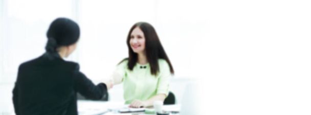 blurred image for the advertising text. photo with copy space. welcome handshake of two business women at the Desk. - Foto, Imagem