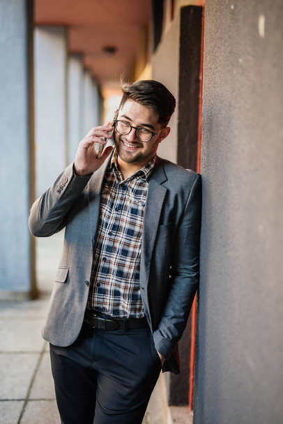Young man talking on his mobile phone - Photo, Image