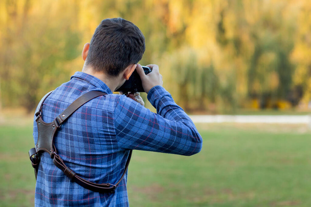 Professional photographer in action with two cameras on a shoulder straps - Foto, Bild