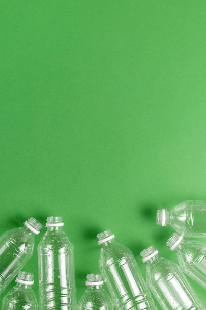 Composition of plastic waste pollution. Sorting and recycling. Disposable plastic bottles for water. Ecological concept. Flat lay, top view, copy space. - Photo, image