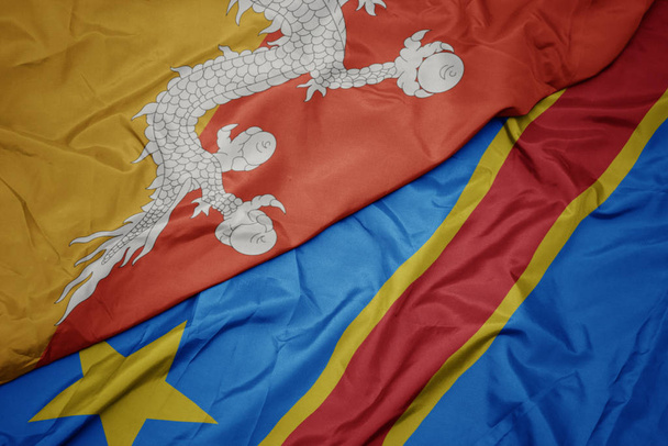 waving colorful flag of democratic republic of the congo and national flag of bhutan. - Photo, Image