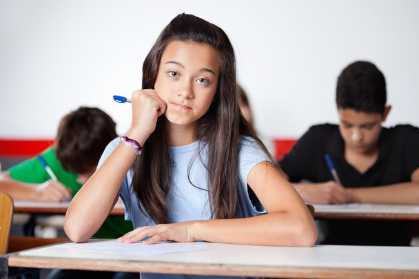 Teenage Schoolgirl Sitting At Desk - Foto, Imagem