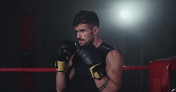 Boxing athletic guy in a boxing ring he practicing cross fit class have a intense workout training - Felvétel, videó